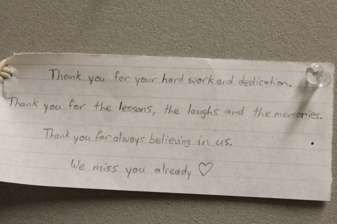 A hand written Thank you note pinned to a wall