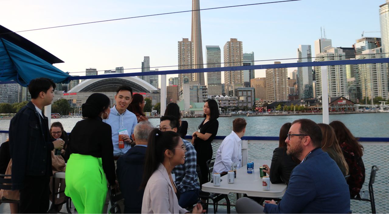 students networking on a cruise with the toronto skyline in the back