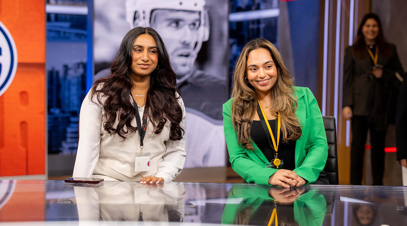 Students at a news desk on live television during TRMC Day