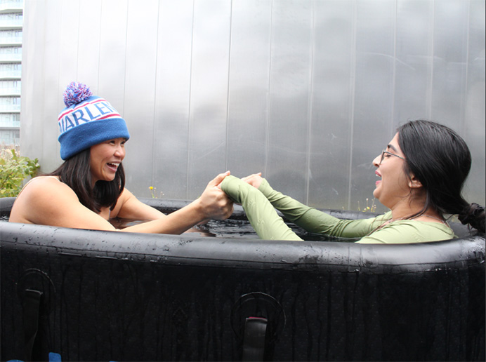 Ellen Choi and a student take a polar plunge in ice water