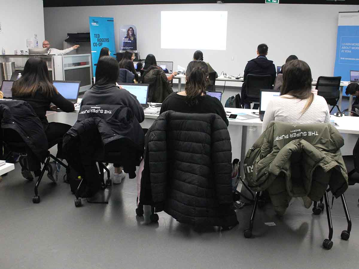 Students sit in front of laptops during Bootcamps masterclass