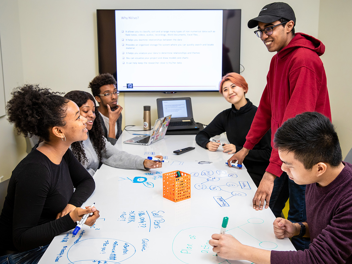 Group of students brainstorming in meeting room