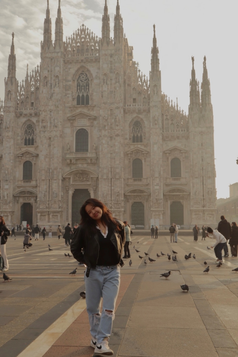 student posing in front of building in spain