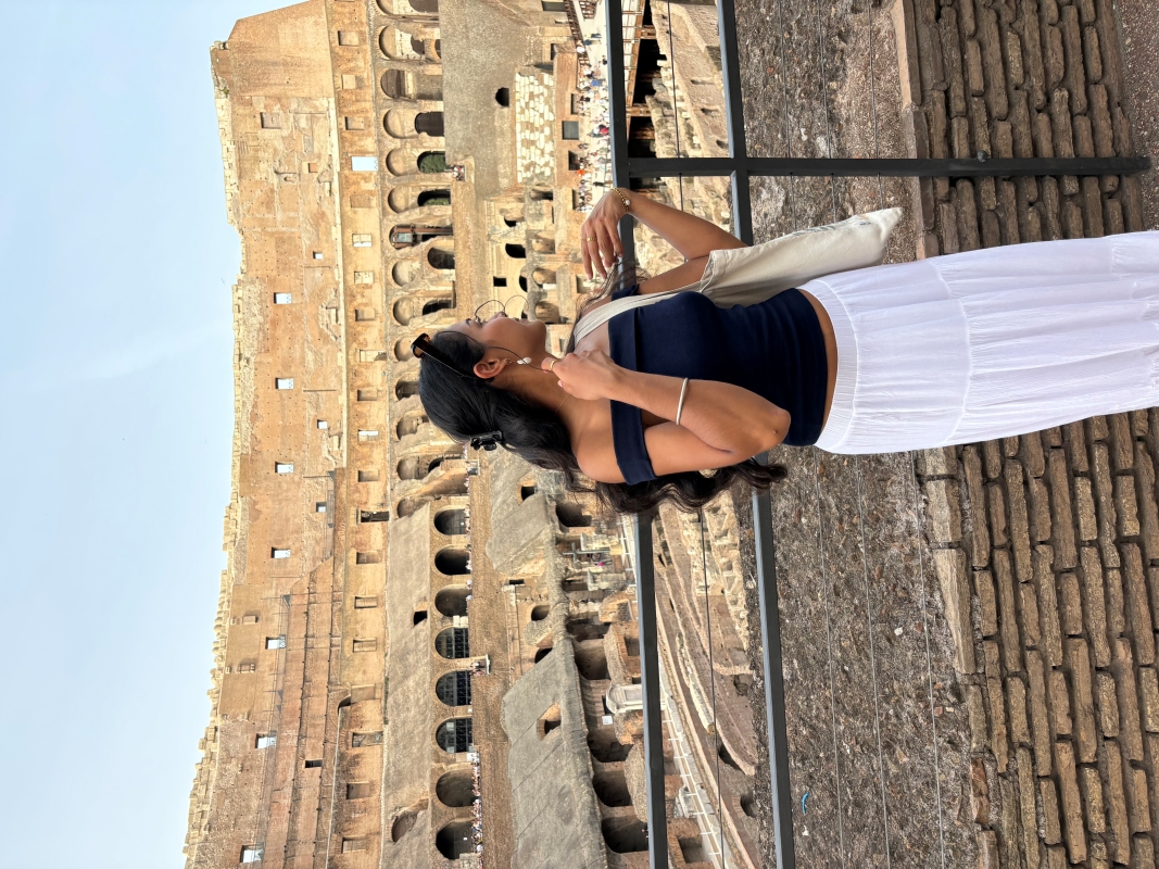 student posing in the colosseum in rome