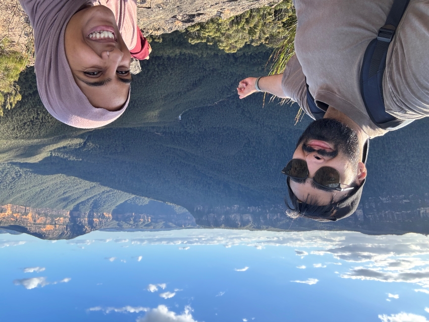 2 students posin fr selfie in front of mountaineous canyons