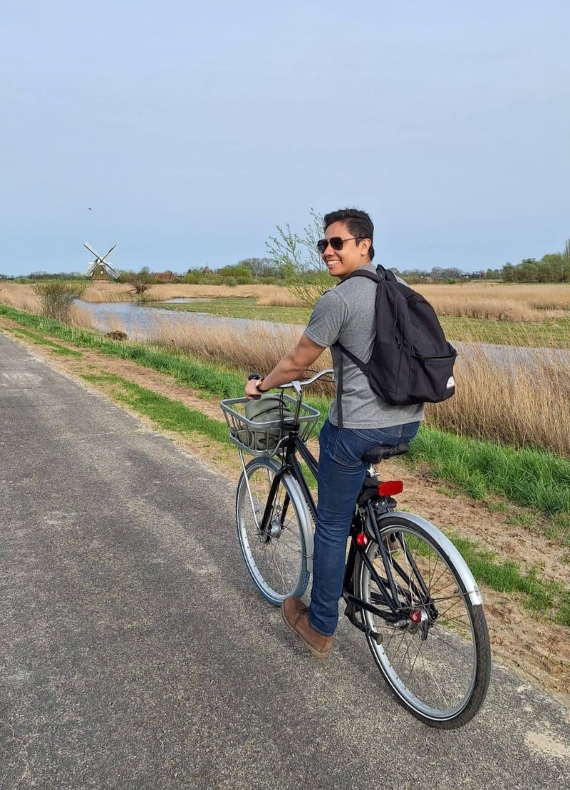 student biking in the countryside in the netherlands
