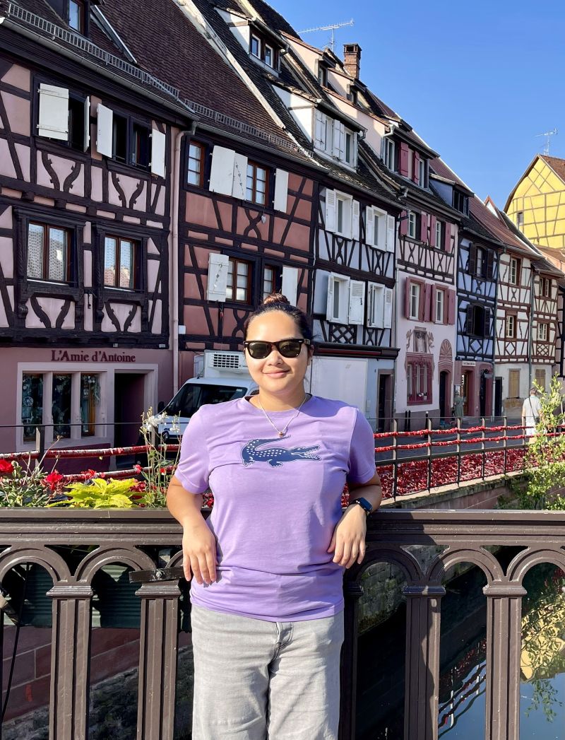 stdent posing in front of traditional buildings in switzerland