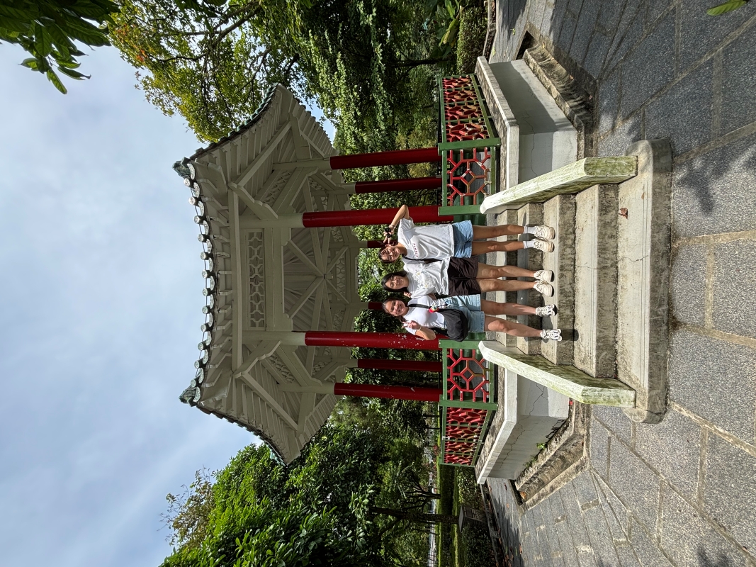 students posing in front of traditional architecture in singapore