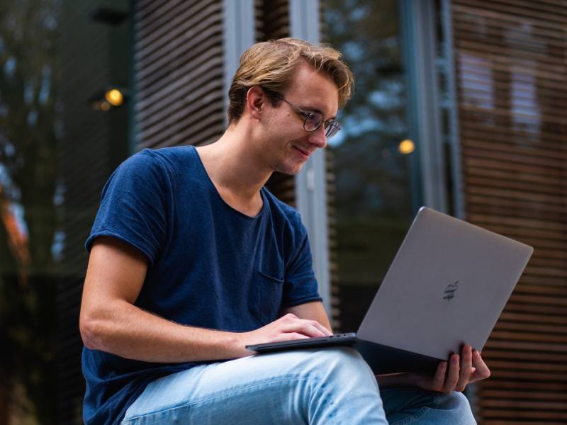 Student on a computer smiling