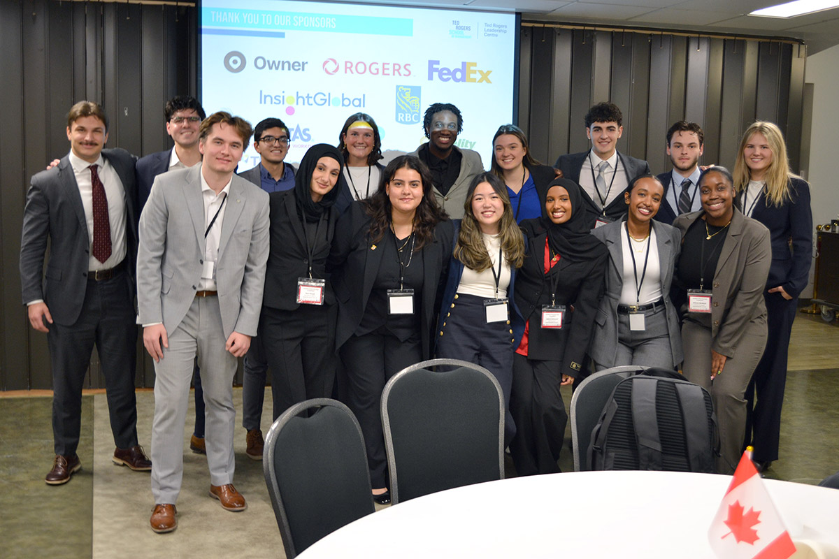 A large and diverse group of people smile for a group photo at the Canadian University Sales Competition (CUSC)
