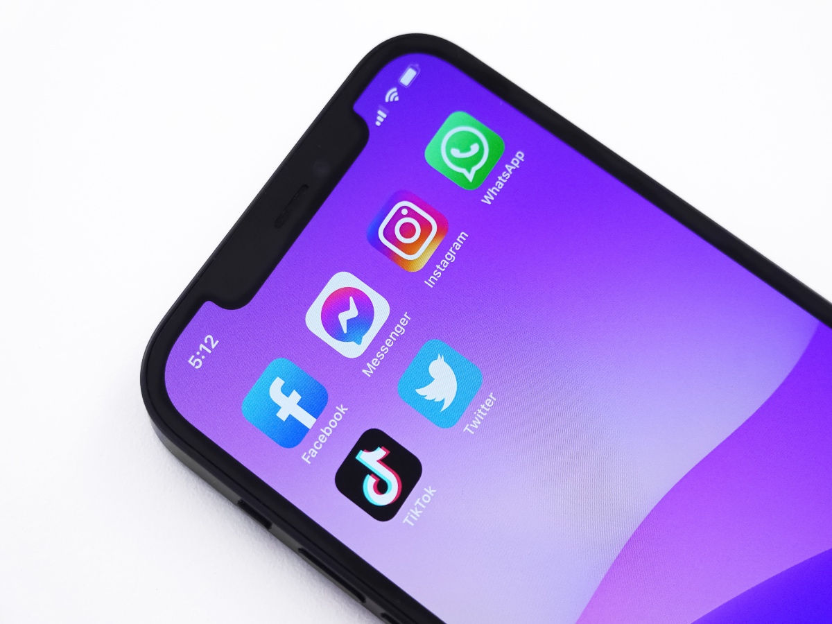 Social media icons on phone with purple background