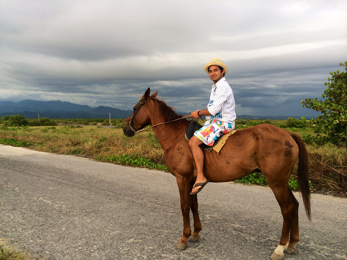 Student on top of a horse in the mountains in Cuba