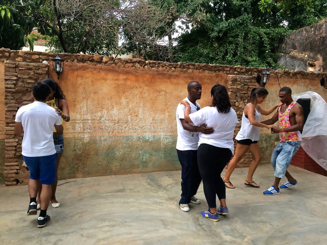 Students learning salsa dancing from locals in trinidad