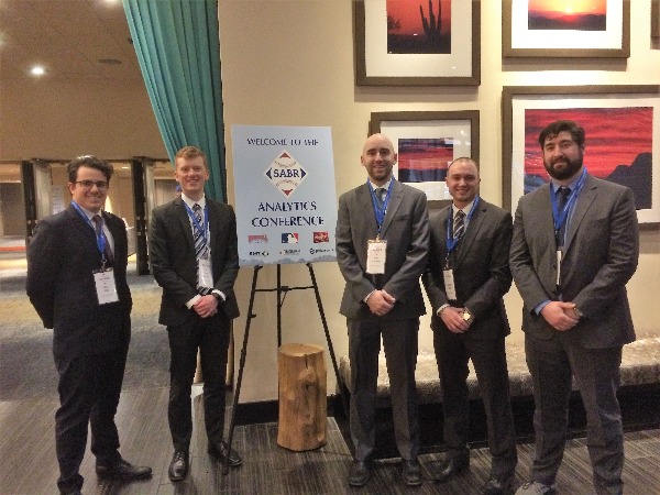 5 excited students pose at the society for American baseball research conference 
