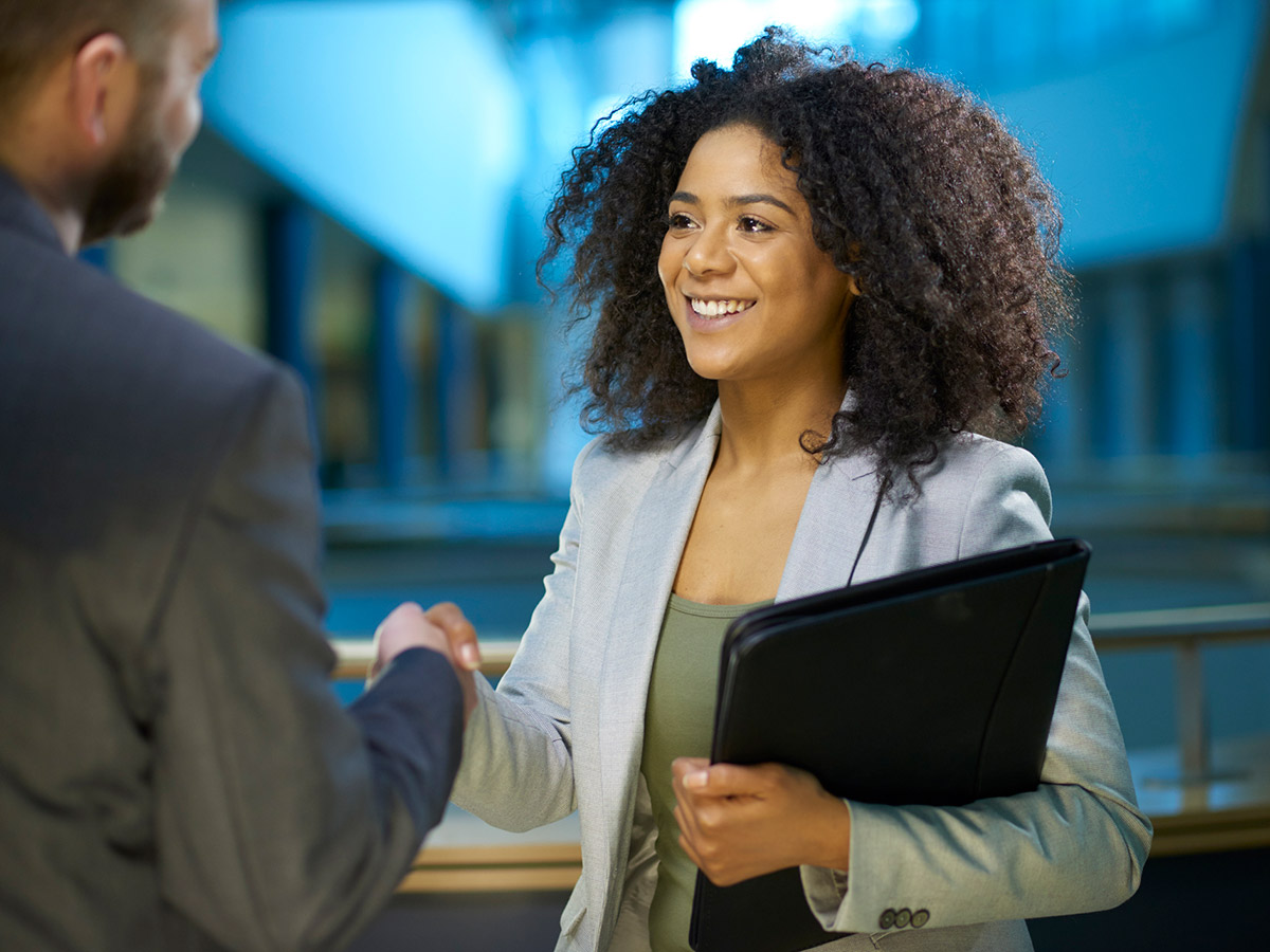 Businesswoman shaking the hand of a man