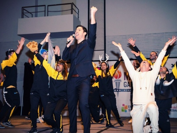 Students singing on stage at MBA Games