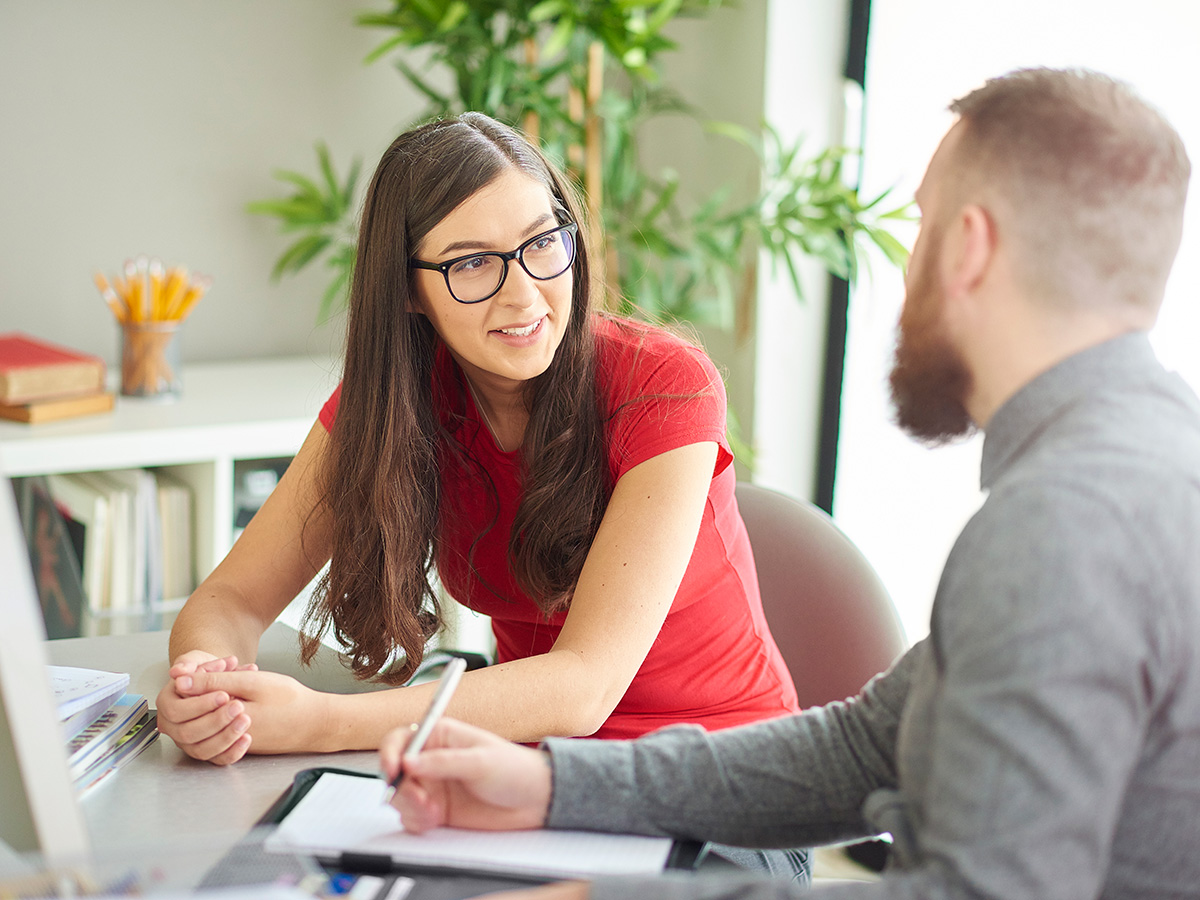 Student talking to advisor in office