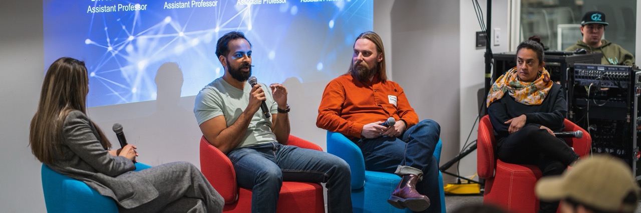 A researcher works in the Creative AI Hub next to a powerful computer tower.