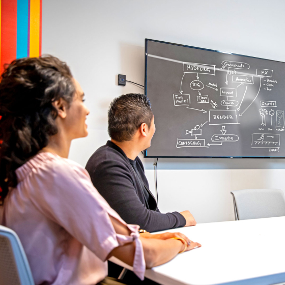 Instructor presenting a workflow diagram to a group of students