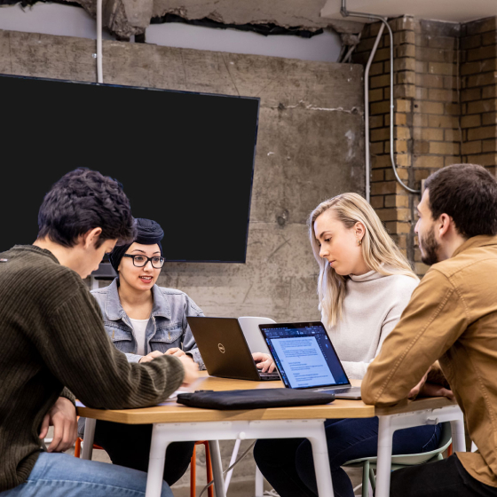 Students at a table collaborating on a project