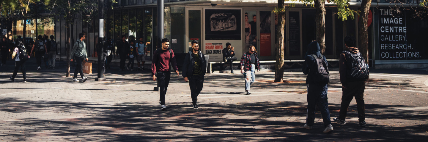 Students walk on Gould St. inside Toronto Metropolitan University's campus