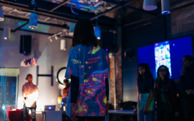 individual wearing a glow in the dark tshirt during the global campus studio showcase as part of their final project presentation