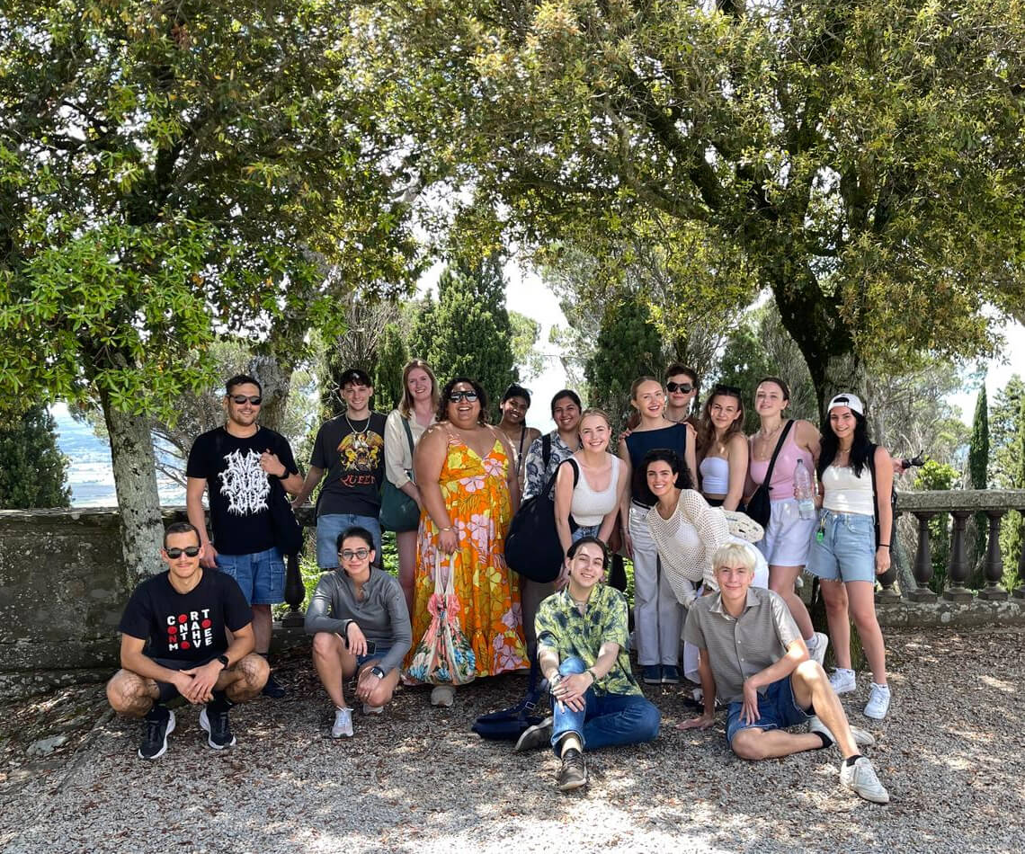 Group of students posing in historic courtyard