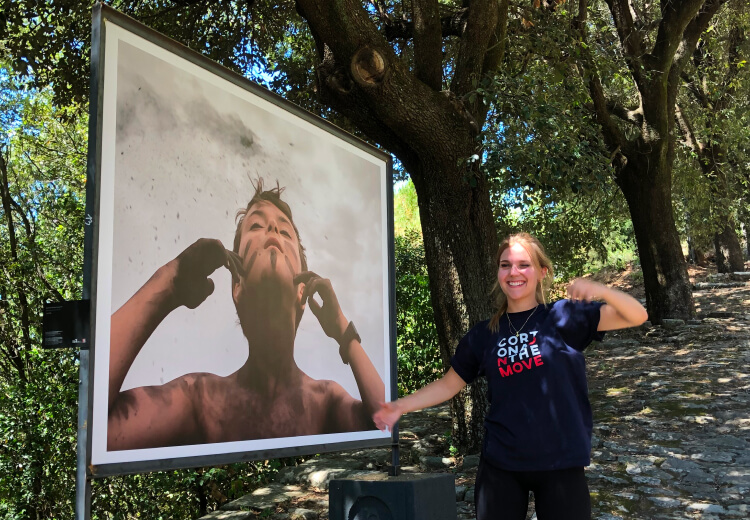 Marilou Vaillancourt standing next to her photo installation in Cortona