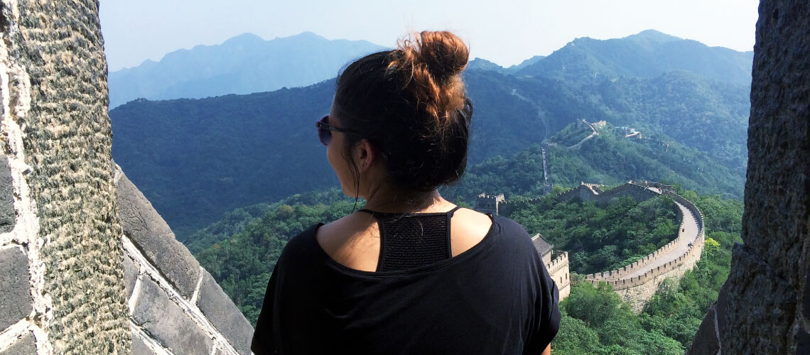 Student looking out over view of Great Wall of China