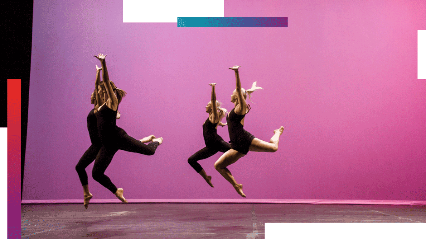 Four students in all black outfits dance across stage with a pink backdrop