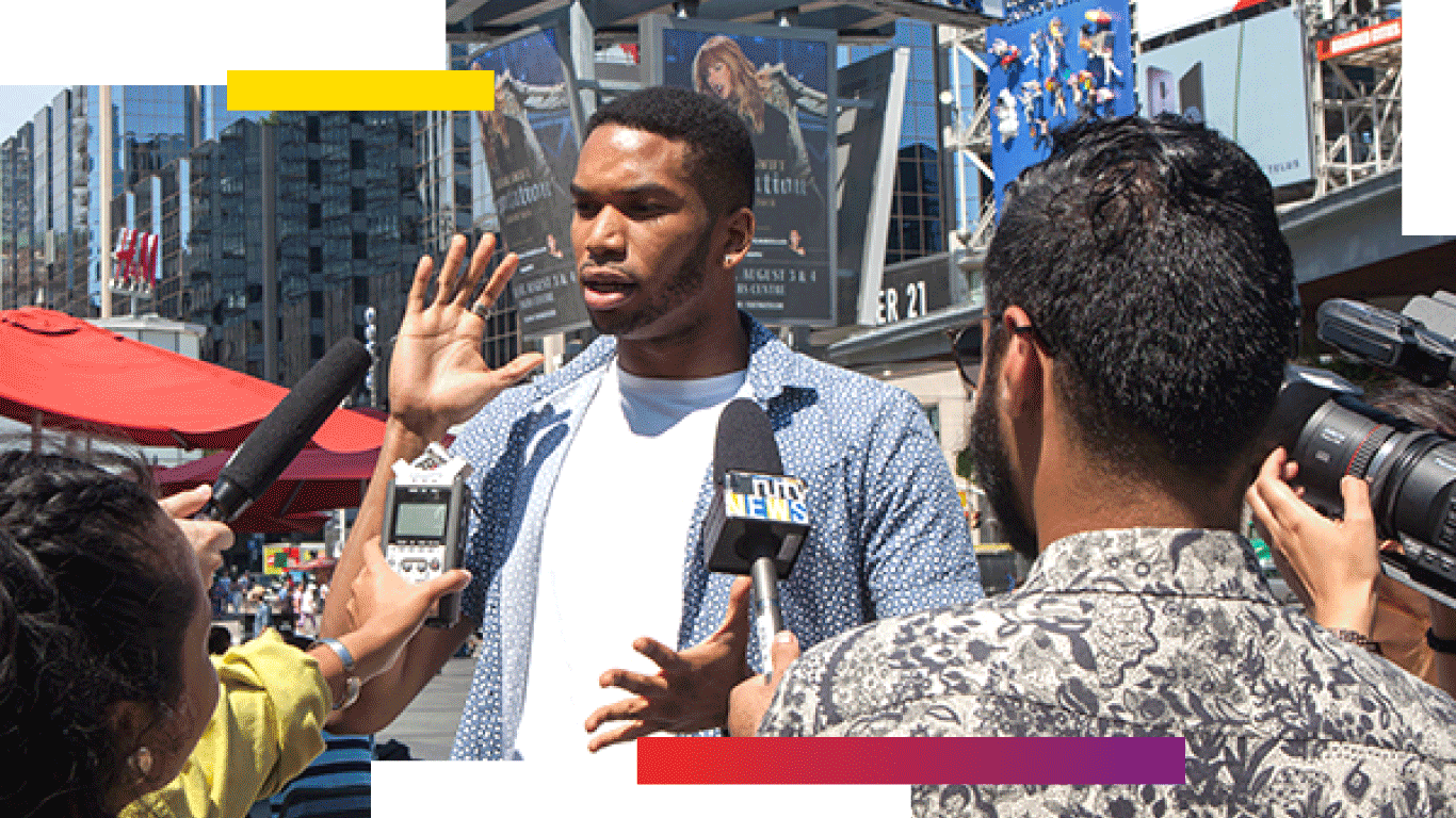 A student being interviewed with a camera crew in Yonge-Dundas square 