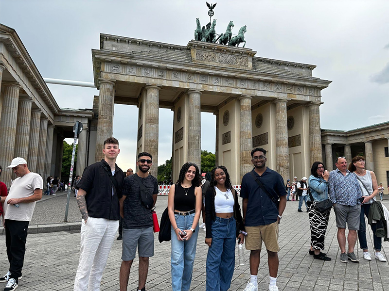 A group of students pose in front of a historical landmark in Berlin.