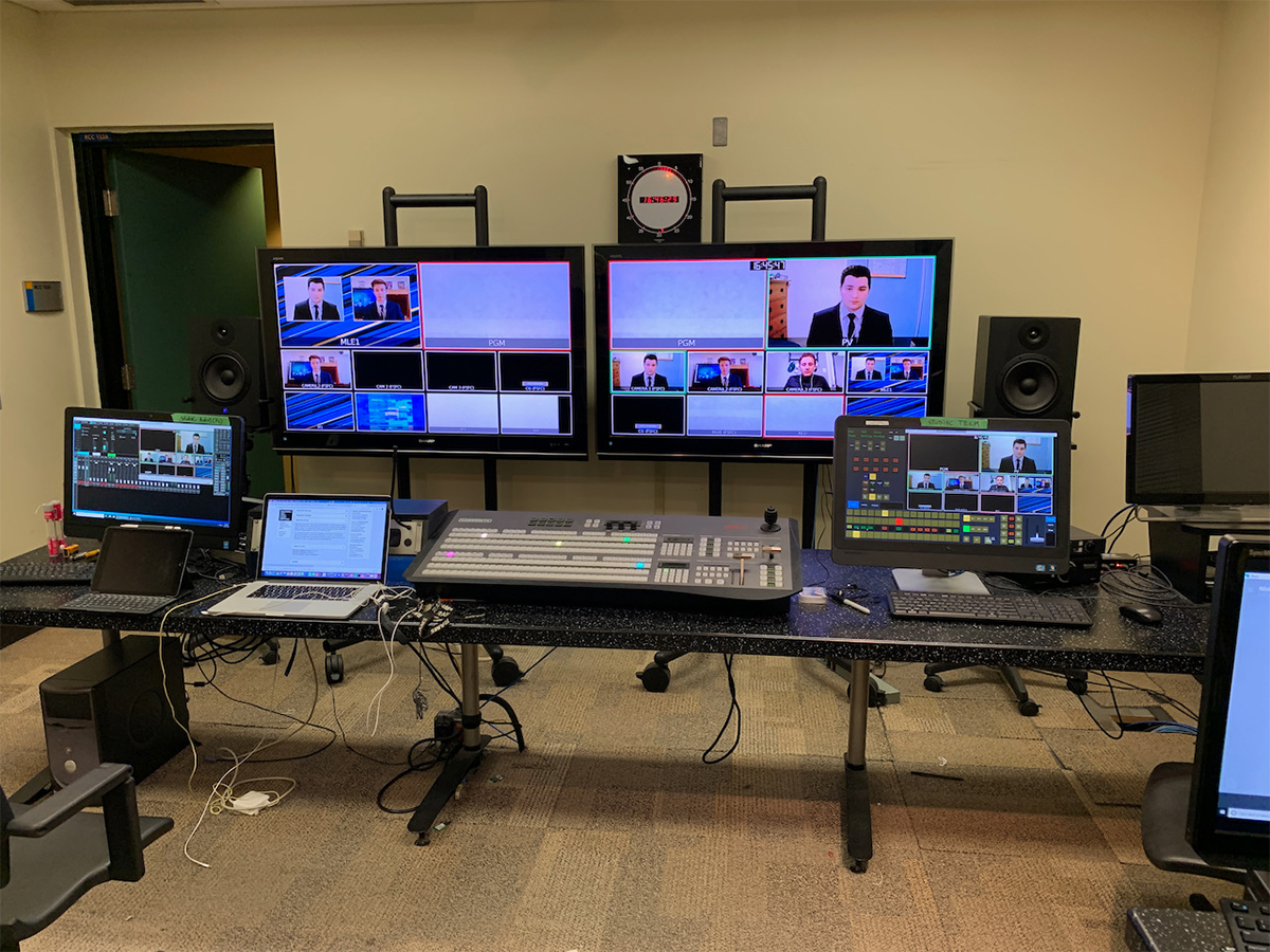 Media production facilities featuring multiple monitors with a live broadcast