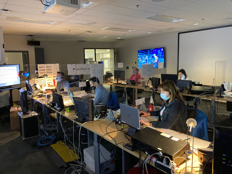 three RTA guests lecturers work with masks on, their desk divided by plastic panels 
