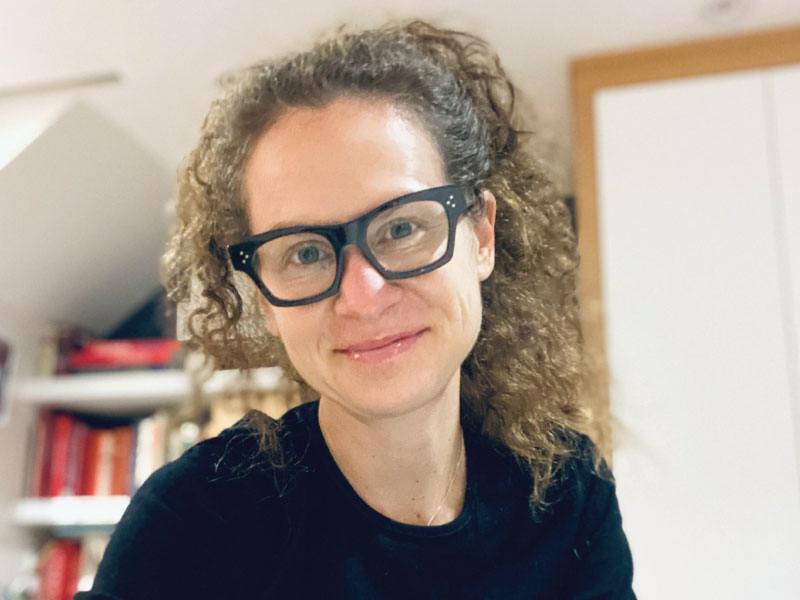 Woman with dark glasses smiling