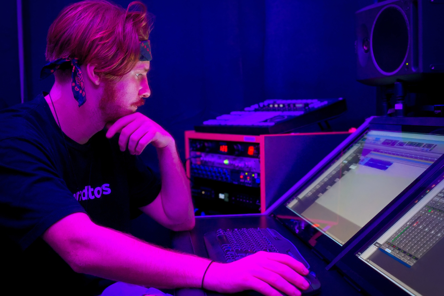 Young man using music soundboard technology