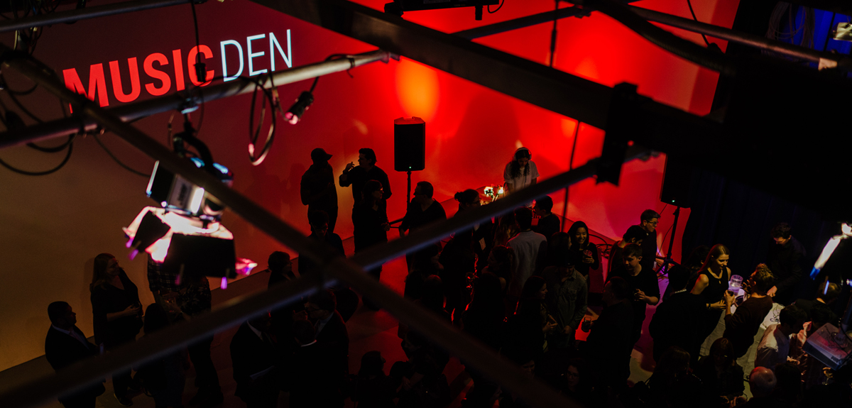 View from above the rafters of a Music Den event space shown with red lighting