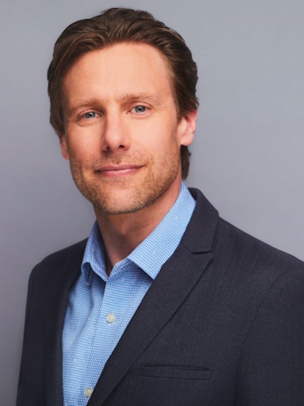 Reynolds Mastin, CEO of the CMPA wearing a blue shirt and a black blazer. He has brown hair