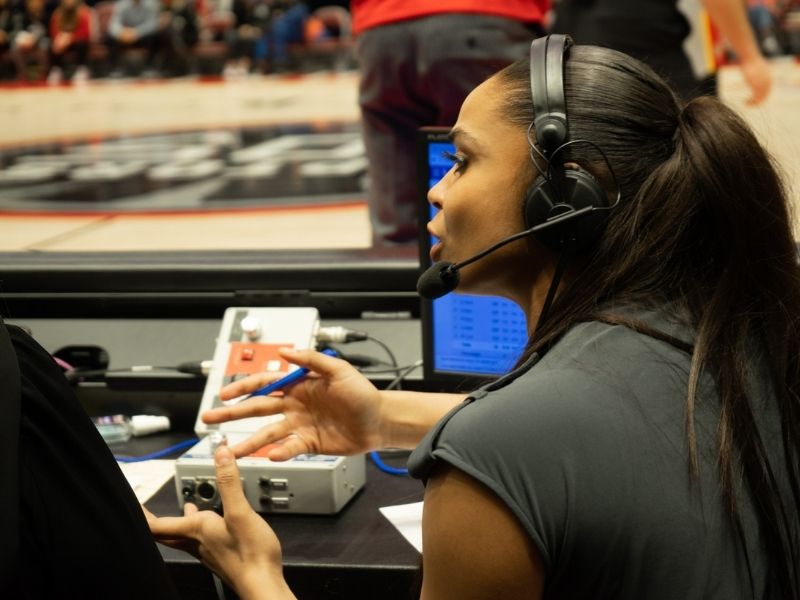 Woman wearing headset in mid conversation about game 