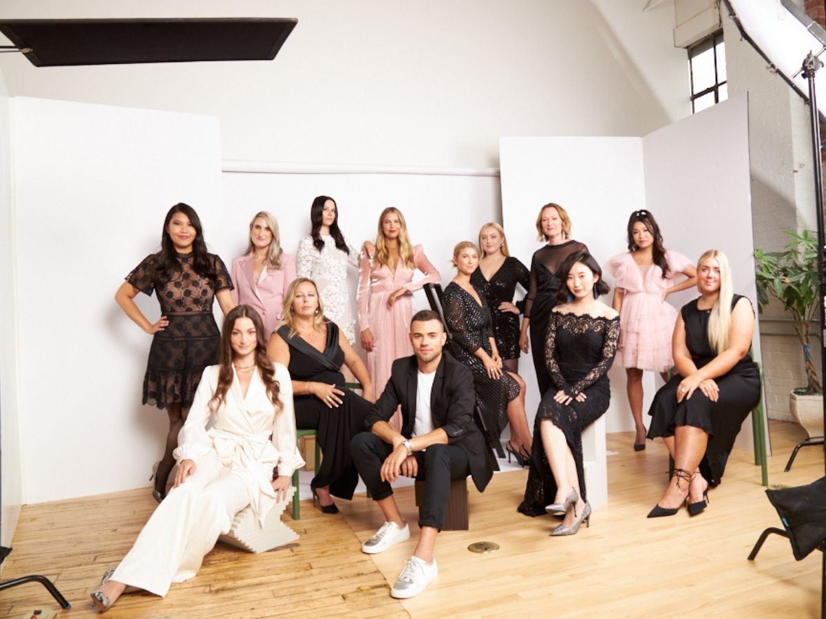 Faulhaber Communications team photo showing men and women posing together in formal attire