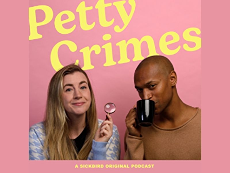 A young woman with blonde hair holds up a magnifying glass, next to a young Black man drinking from a mug