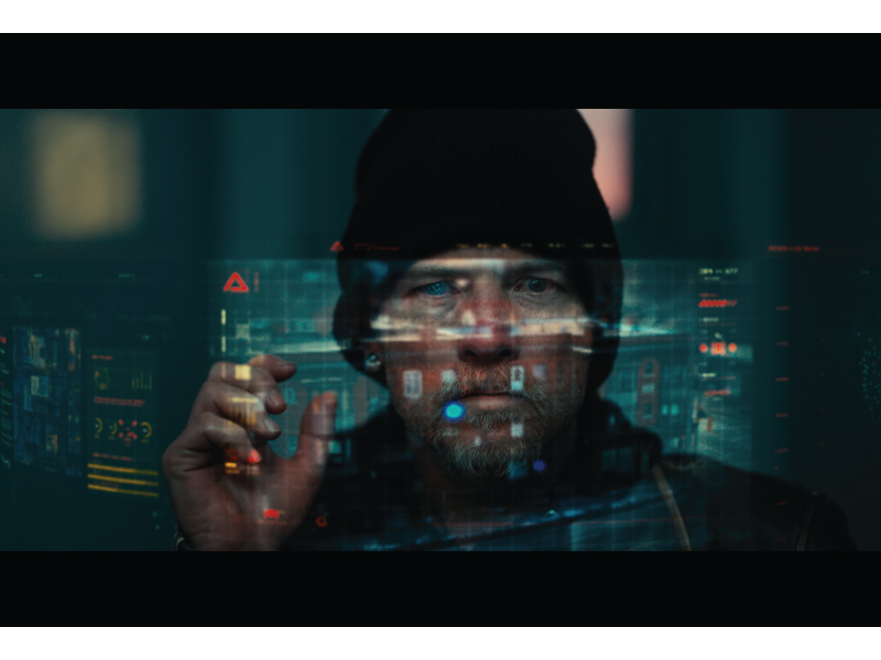 A still from Simulant with a man looking at a holographic image