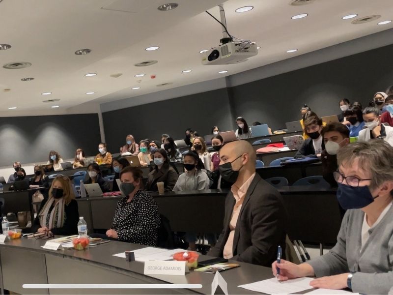 Lecture hall with circular desk seating hosts professionals and students