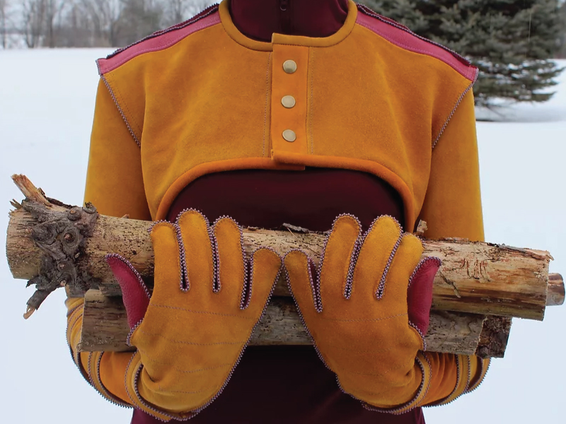 A yellow jacket with matching gloves, decorated with beading across the outline of the fingertips