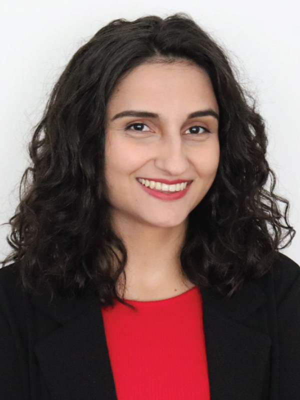 A portrait of Annemarie Cutruzzola with black curly hair and a red shirt