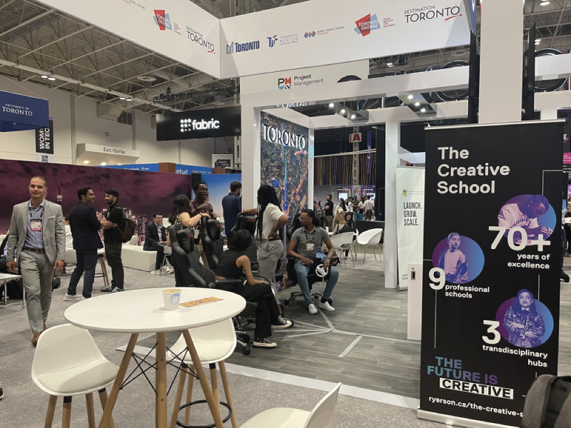 Dr. Kristopher Alexander speaking with attendees at The Toronto Pavillion representing The Creative School 