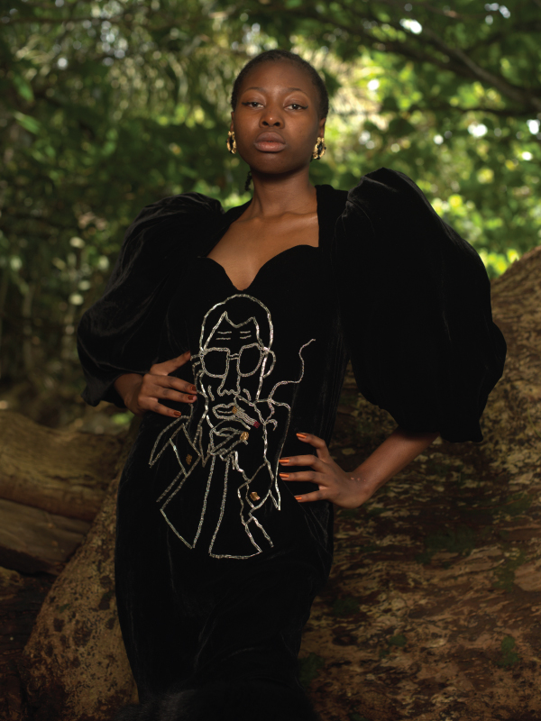 An African woman posing in a black dress