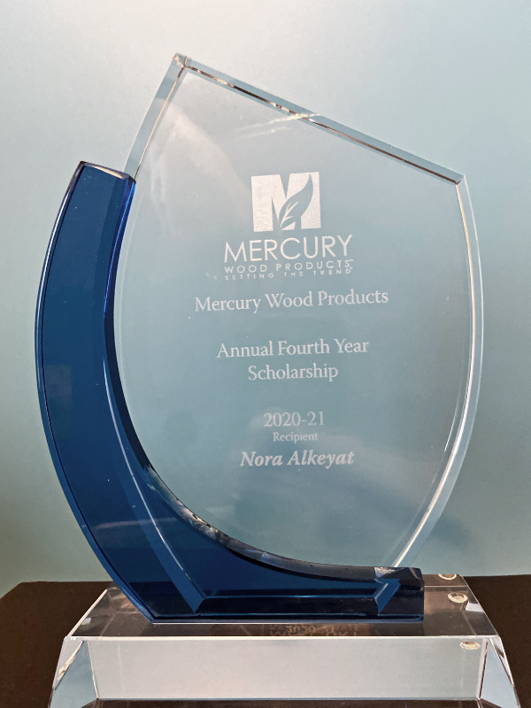 Clear Trophy with Mercury Wood Products, Annual Fourth Year Scholarship written on it 