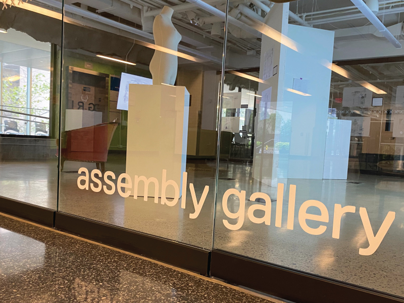 A clear glass wall with the words 'assembly gallery'
