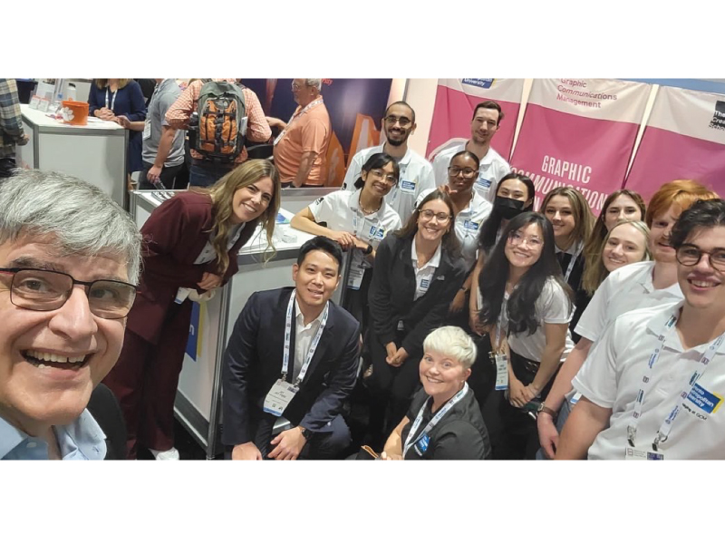 Dean Charles Falzon takes a selfie with students, GCM Interim Chair Natalia Lumby and GCM Professor Jay Park in Chicago at the PACK EXPO Conference